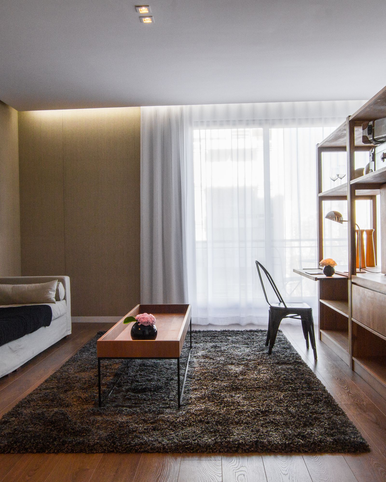 Hotel public area with wood panelling, custom furniture and continuous flooring.
