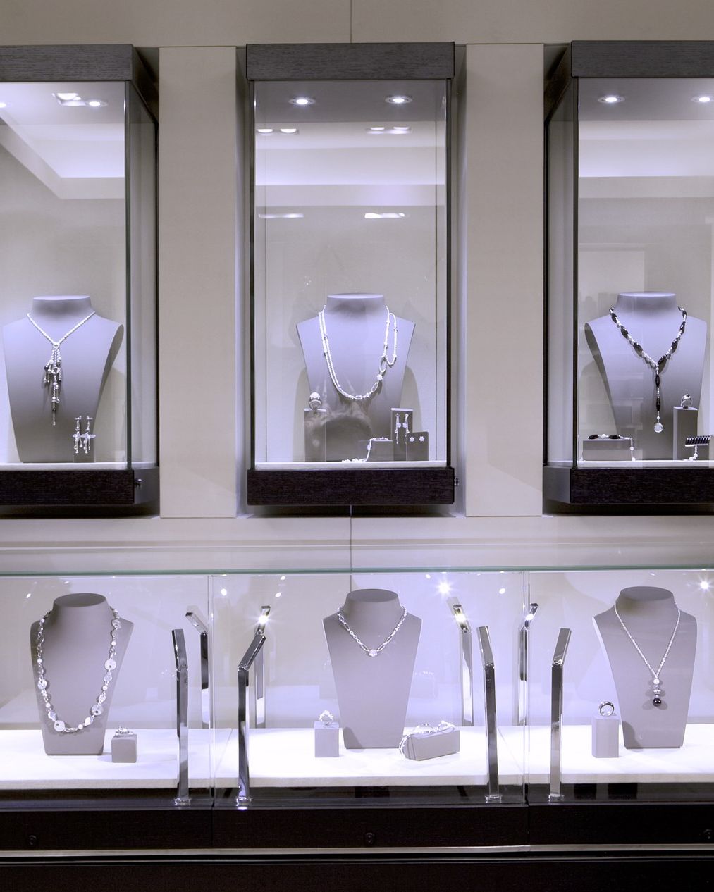 Fine-watchmaking display case: glass, wood and integrated lighting, to minimal tolerances.