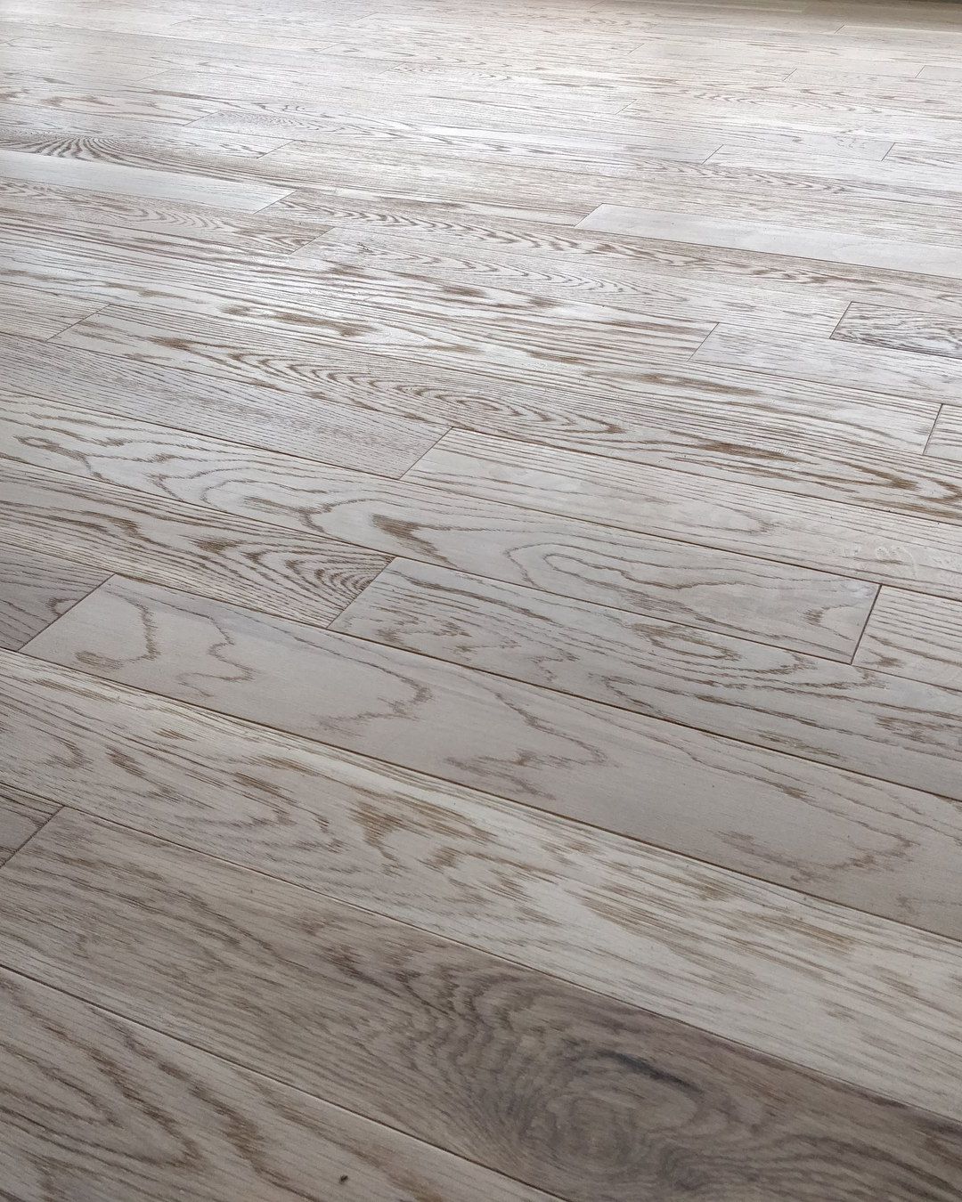Wood flooring laid in a large-scale space, with the grain in the foreground.